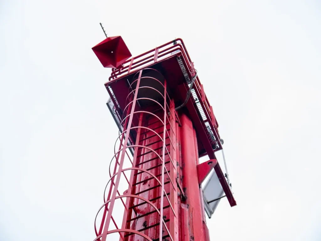 a tall red tower with a sky background