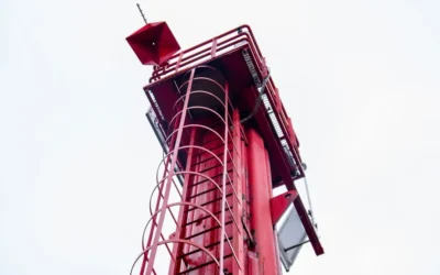 a tall red tower with a sky background